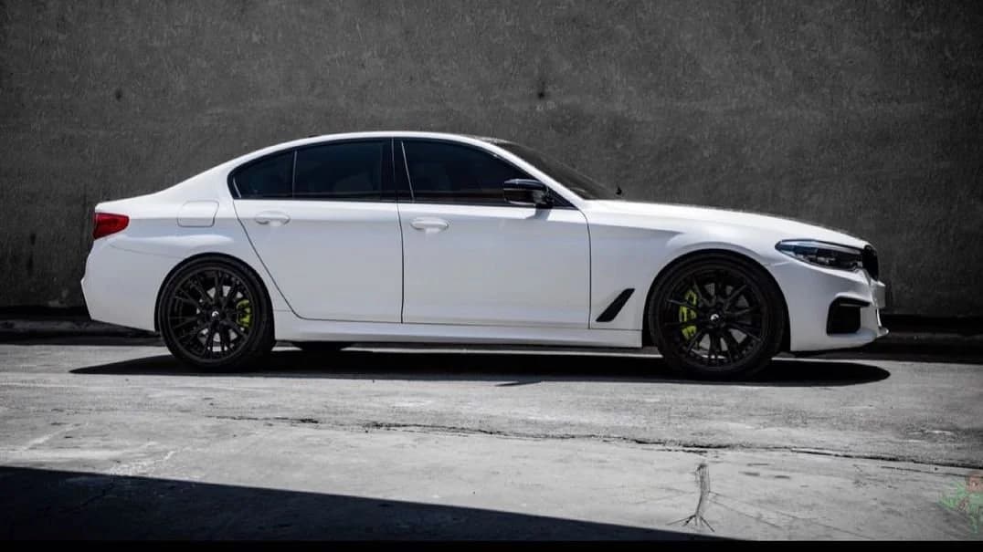 BMW M550i finished in matte white with Forgiato wheels at HADD Customs in Beverly Hills